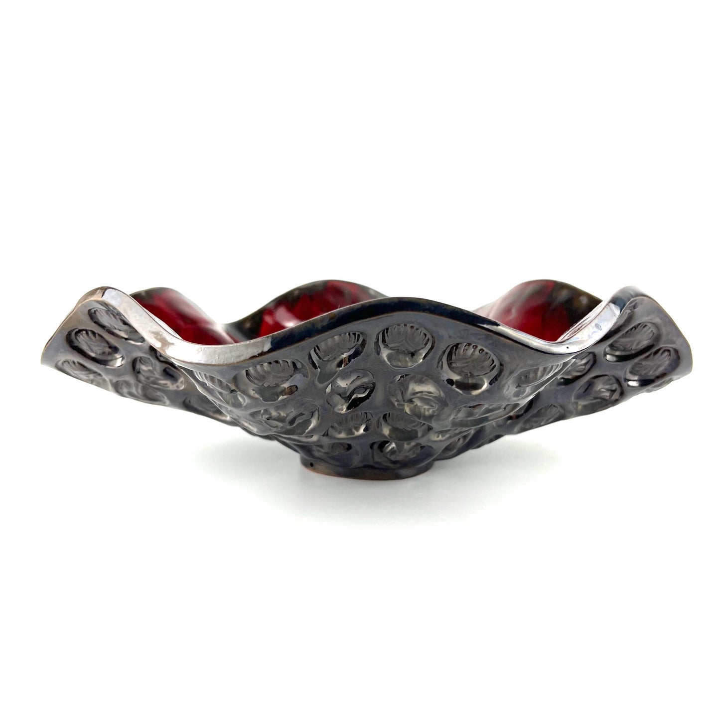 Side view of a handmade large-sized decorative ceramic bowl featuring a rich red interior and tree, ant, and beetle texture design.
