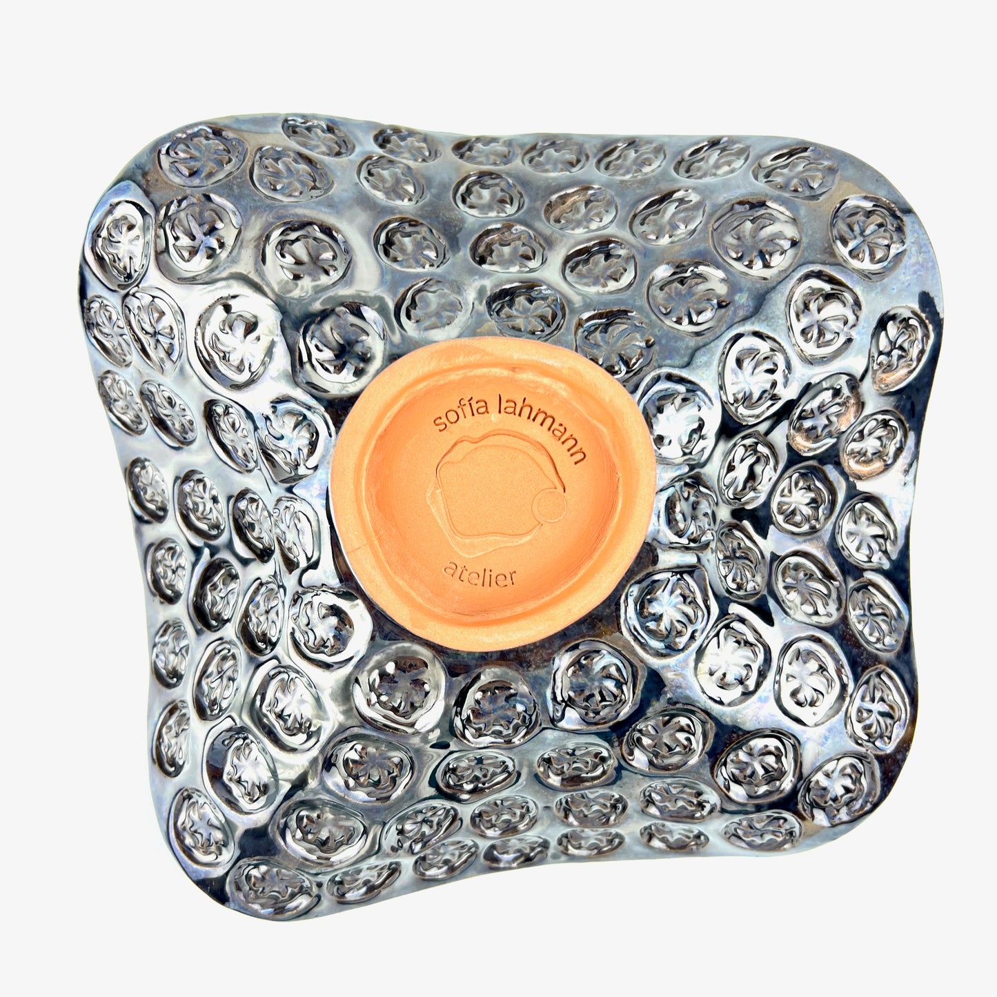 Top view of the textured star-stamp exterior with dark metallic glaze on a handmade medium ceramic bowl.
