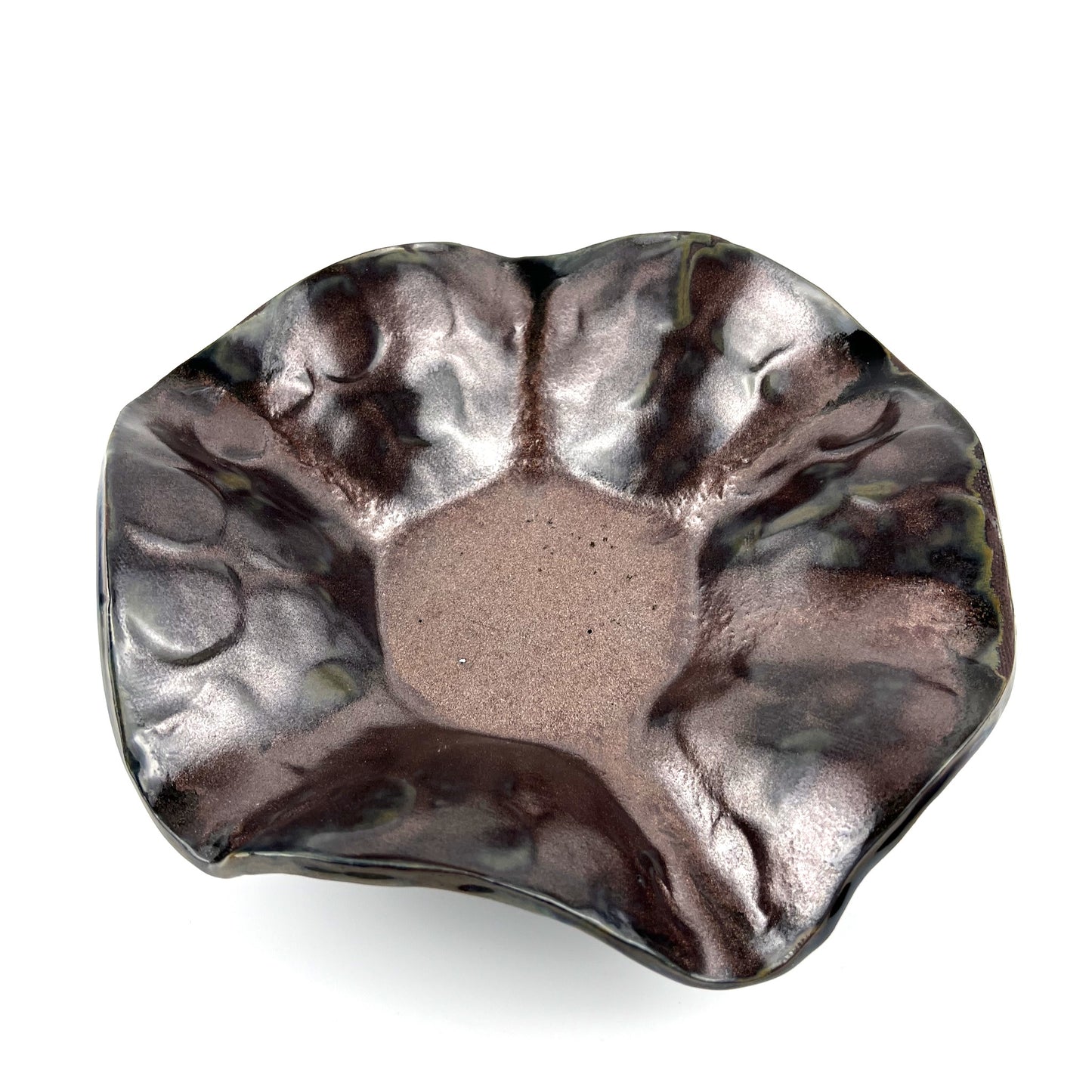 Handmade small decorative ceramic bowl with a rose gold interior and textured hand design.
