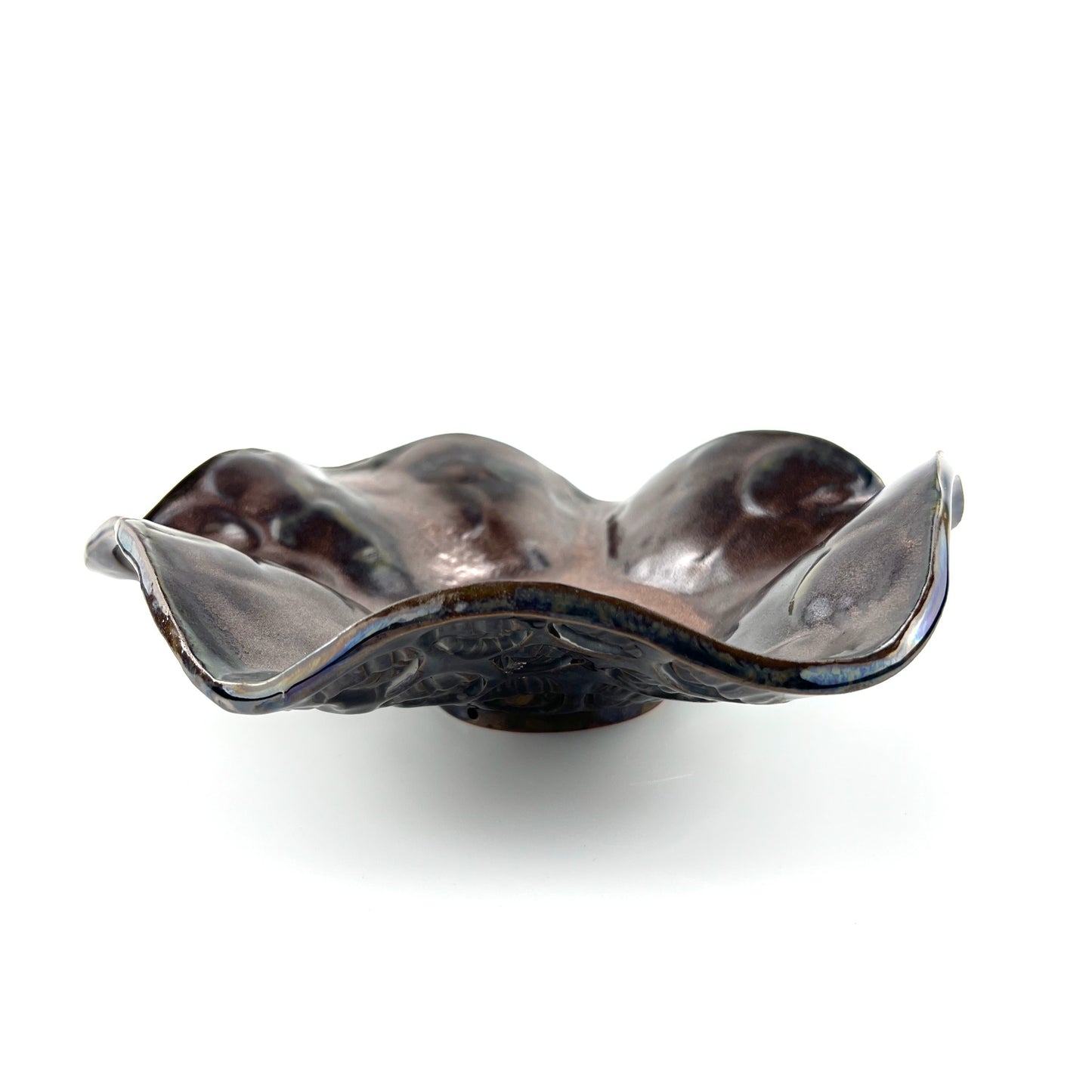 Side view of a handmade small decorative ceramic bowl featuring a rose gold interior and hand texture design.