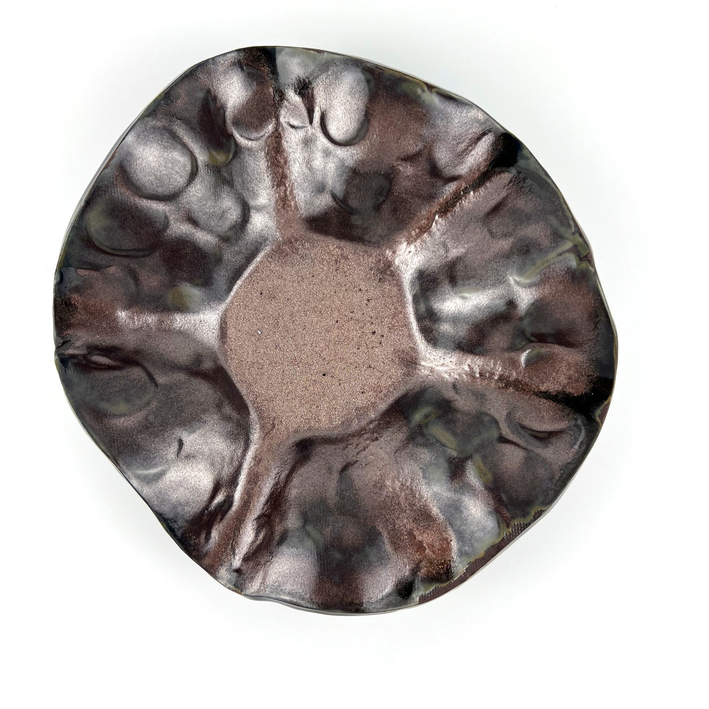 Top view of the shimmering rose gold interior of a handmade small ceramic bowl.