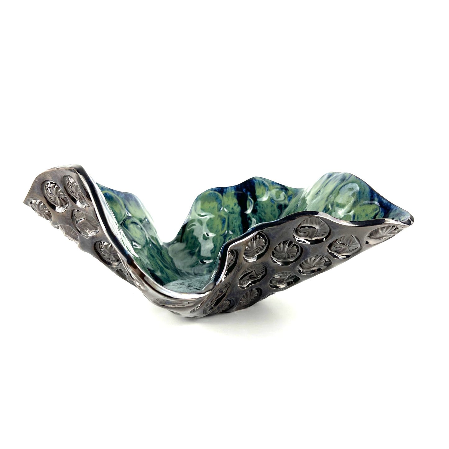 Side view of a handmade extra-large decorative ceramic bowl featuring a glossy cornflower blue base with navy, seafoam, and lime green accents and sunshine texture design.