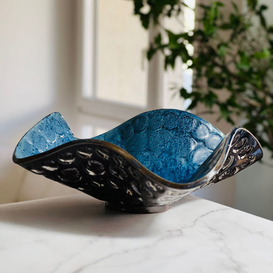 Handmade large-sized decorative royal blue ceramic bowl with sunshine and ant texture displayed on a marble table with a living room background.