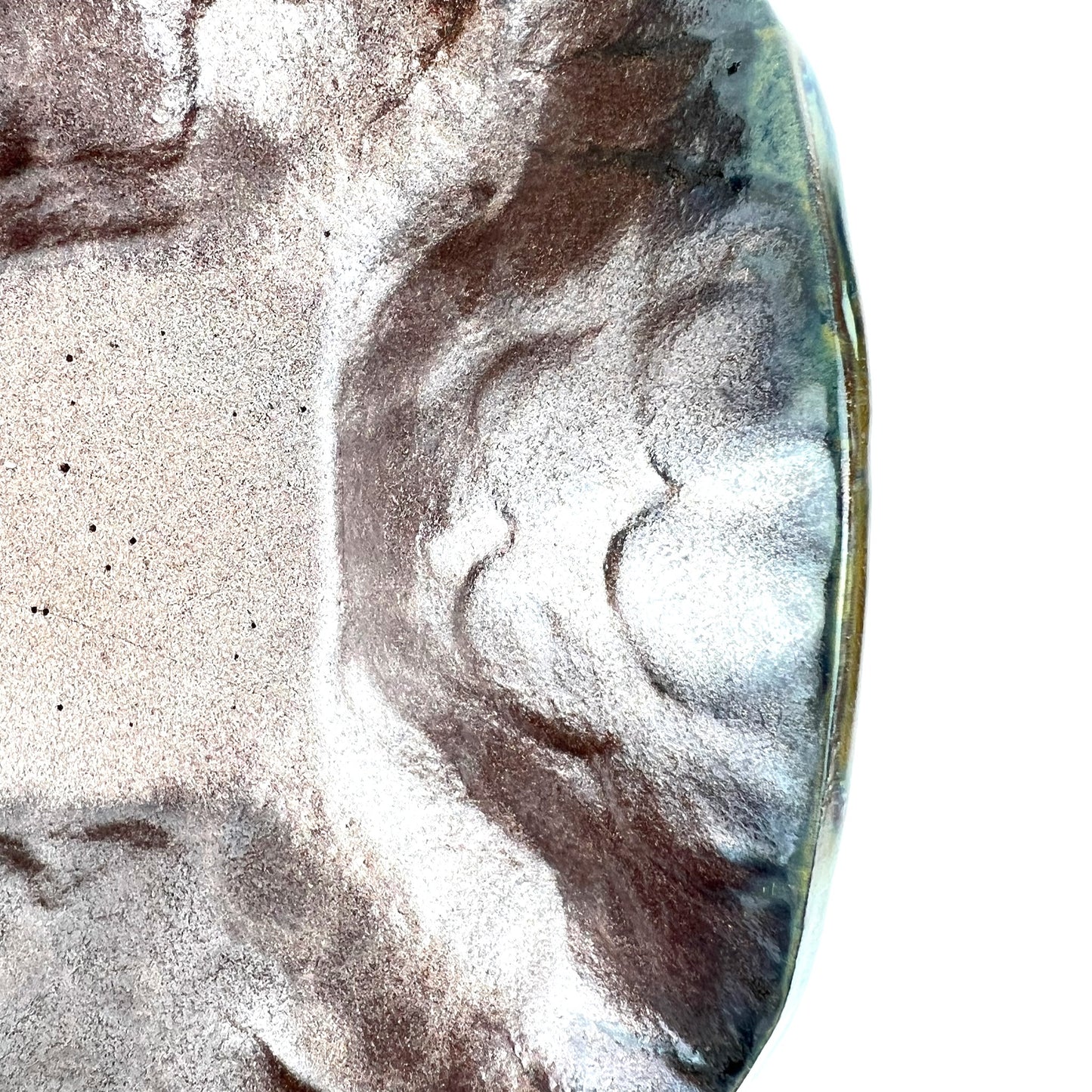 Close-up of the shimmering rose gold interior of a handmade medium ceramic bowl.