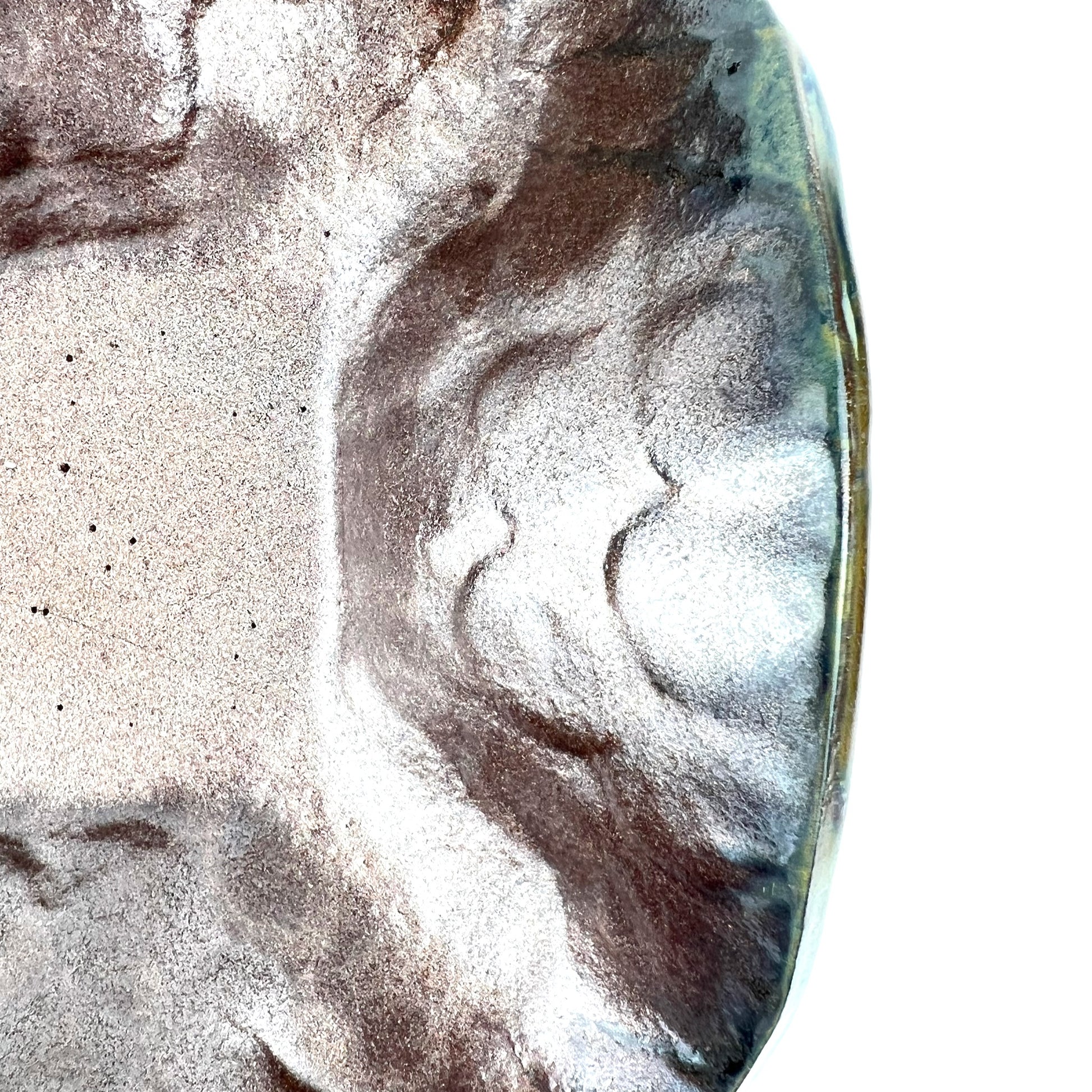 Close-up of the shimmering rose gold interior of a handmade medium ceramic bowl.