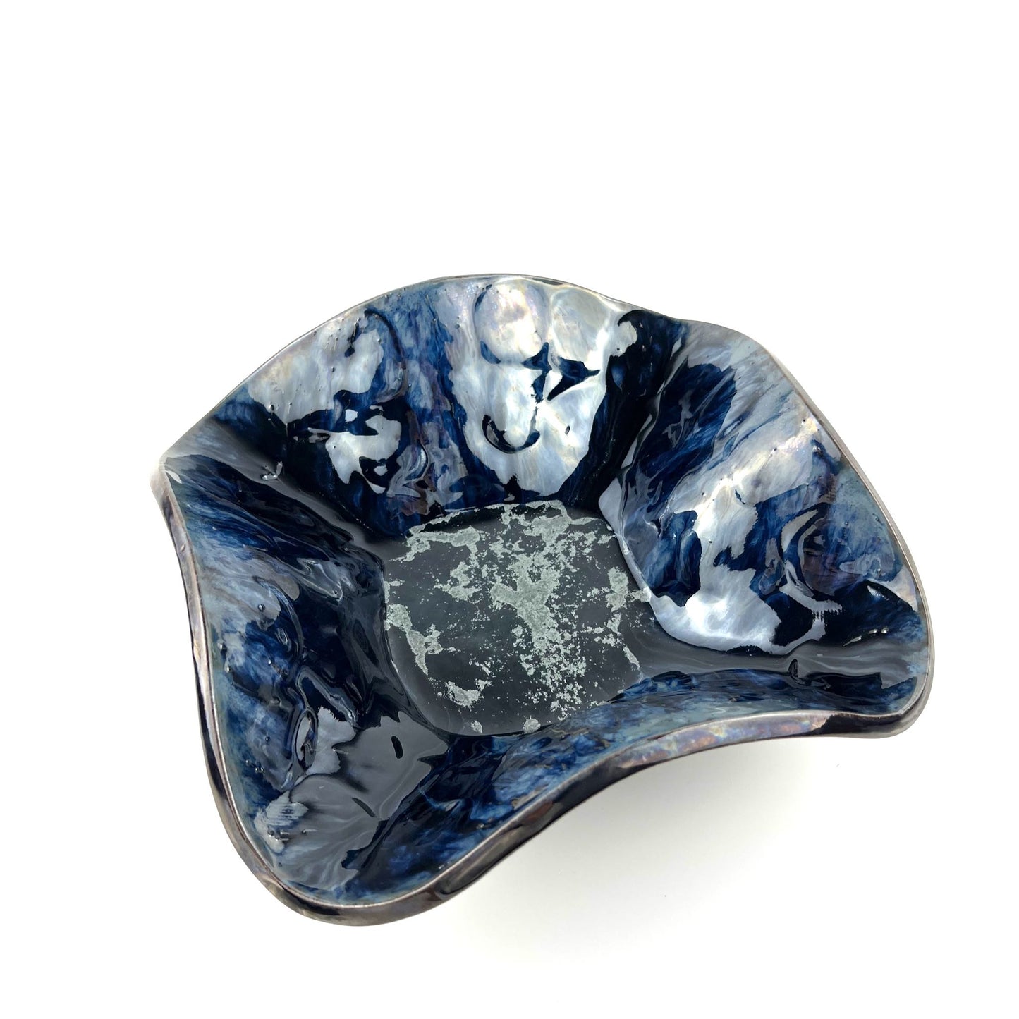 Handmade medium-sized decorative ceramic bowl with a glossy dark blue base, silver accents, and textured half-flower and tree design.