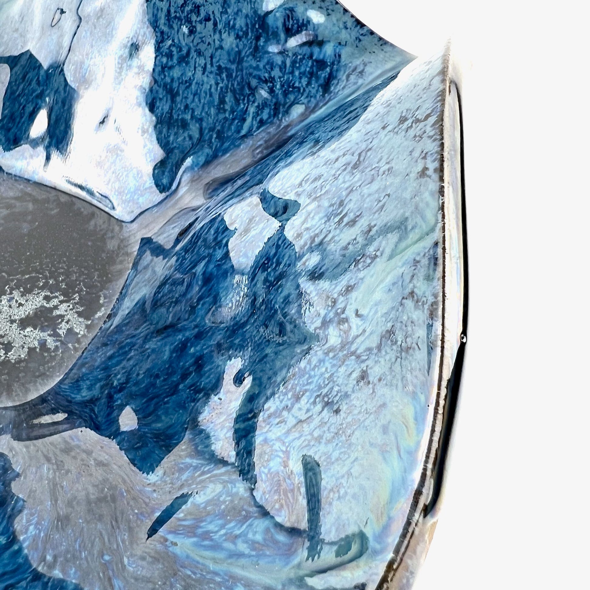 Close-up of the glossy royal blue interior of a handmade medium-sized ceramic bowl.