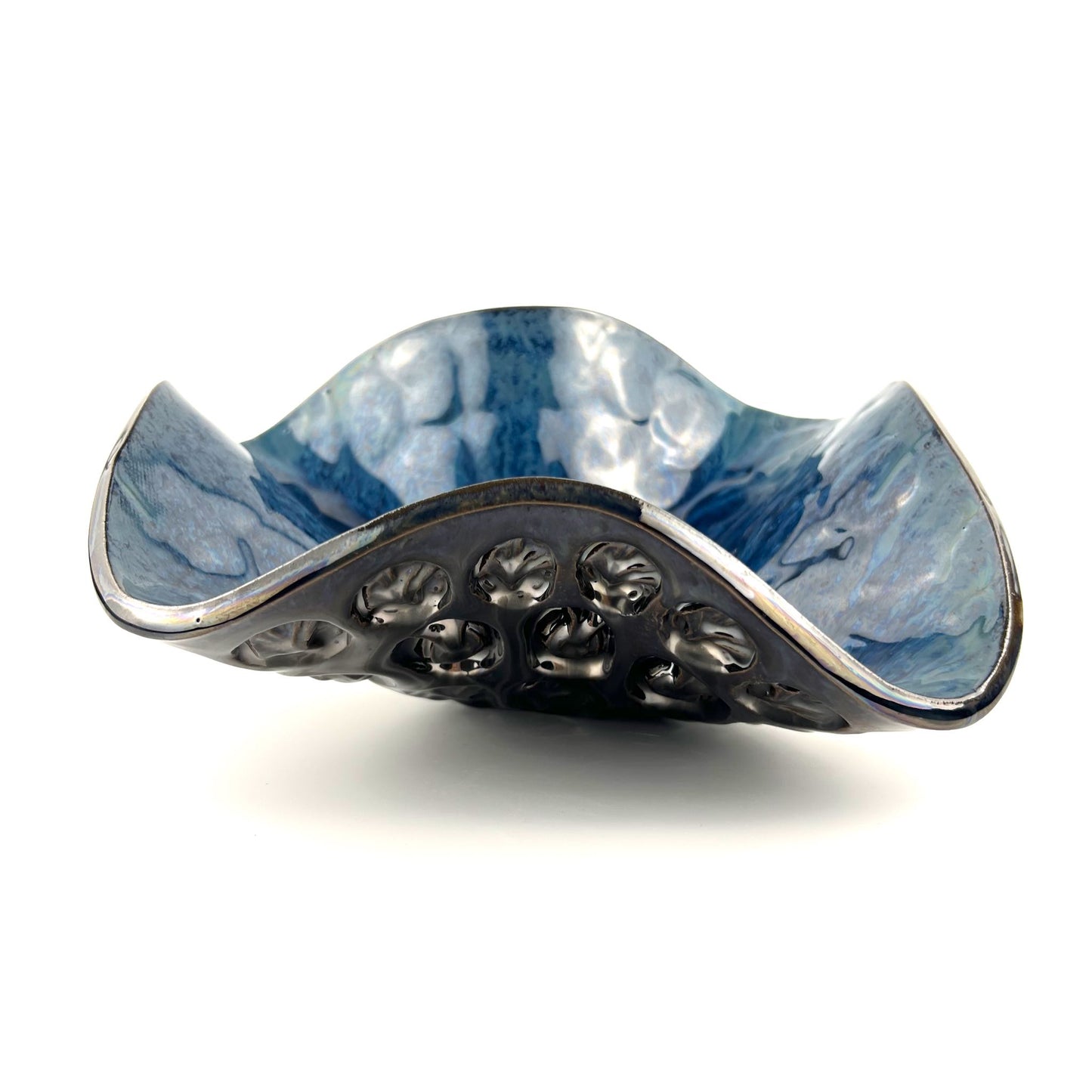 Side view of a handmade medium-sized decorative ceramic bowl featuring a royal blue interior and Tree and Ant texture design