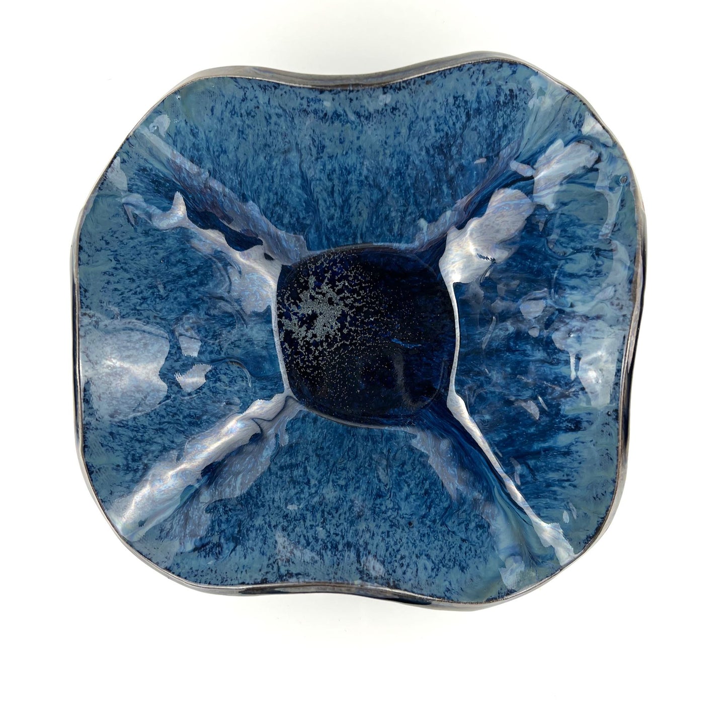 Top view of the shimmering royal blue interior of a handmade medium-sized ceramic bowl.