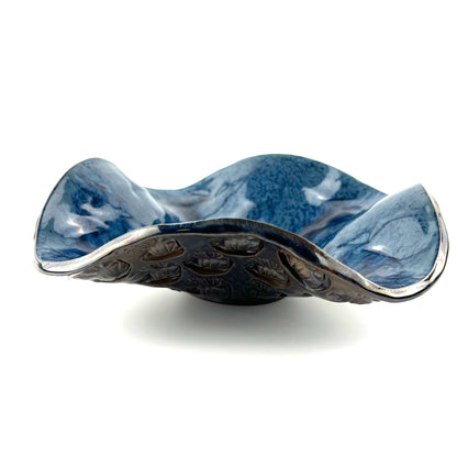 Side view of a handmade small decorative ceramic bowl featuring a royal blue interior and Trio of Leaves texture design.