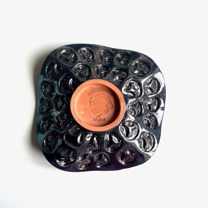 Top view of the textured tree exterior with dark metallic glaze on a handmade small-sized ceramic bowl.