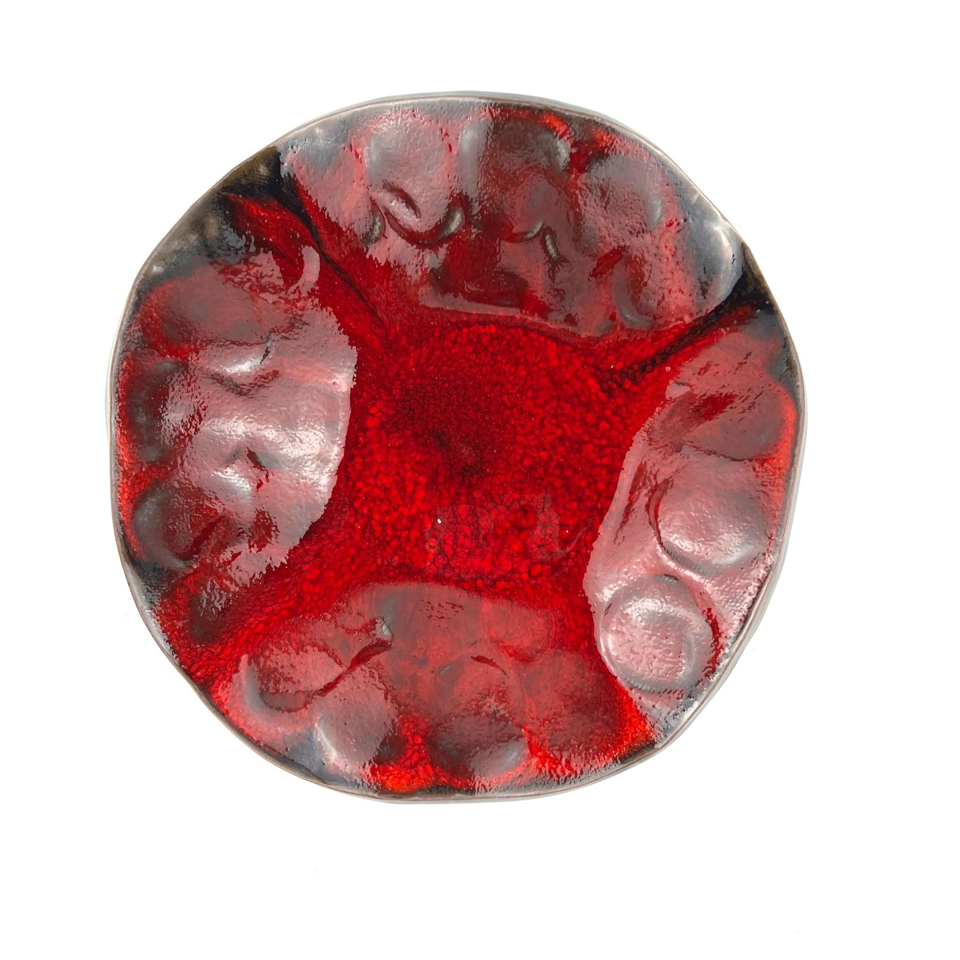 Top view of the glossy rich red interior of a handmade small-sized ceramic bowl.