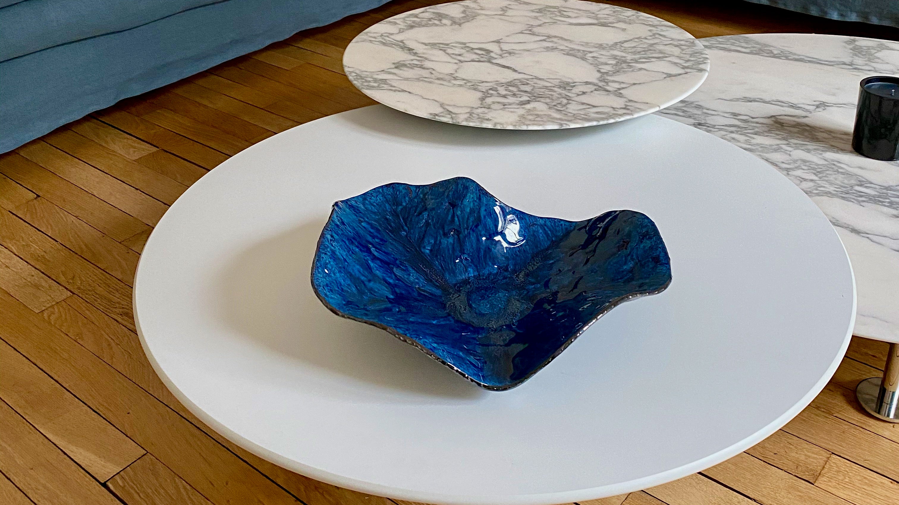 Blue decorative ceramic bowl on white coffee table